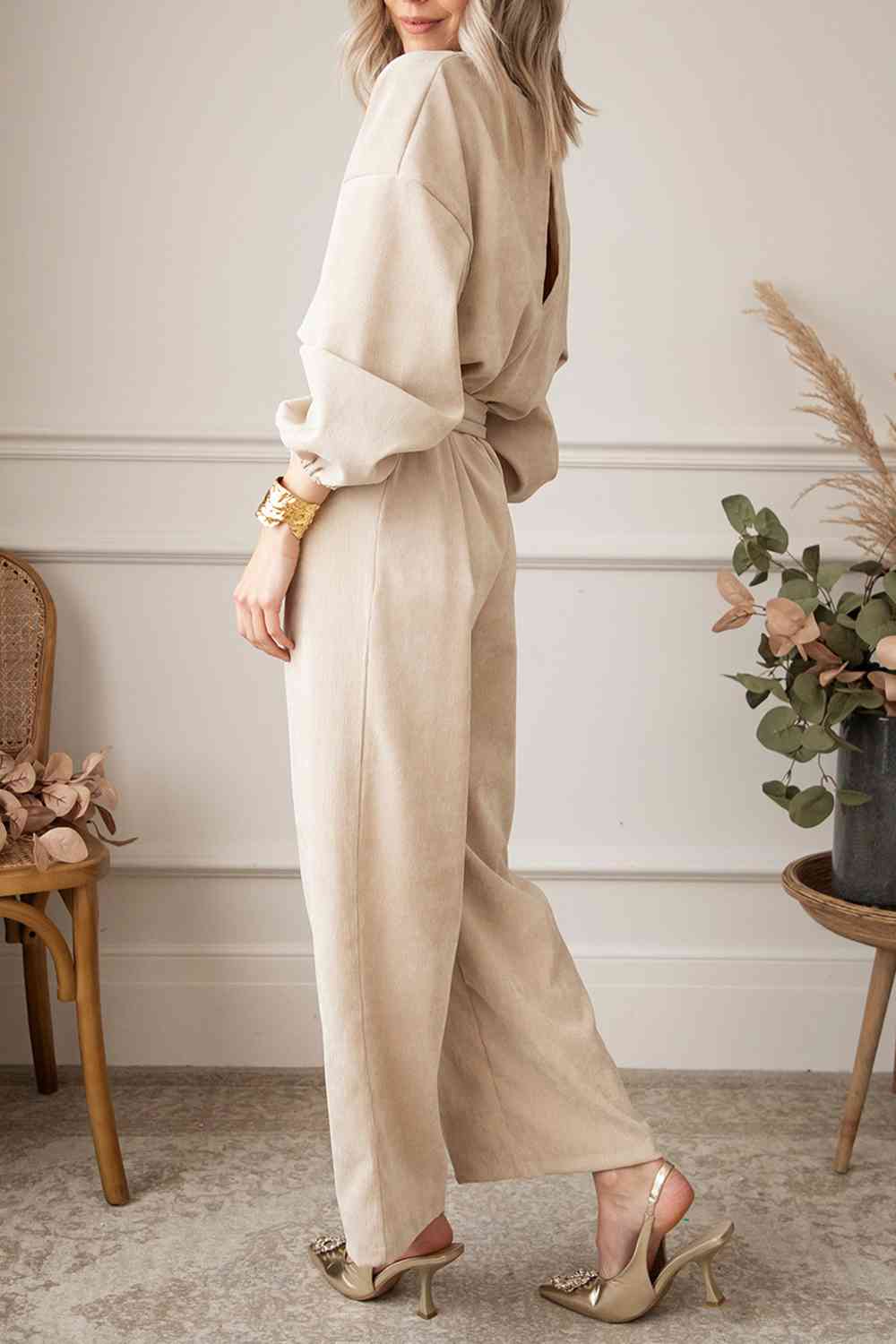 This jumpsuit features a tie waist, trendy v-neck, and wide leg design, making it a must-have trend from Trendsi Trends.