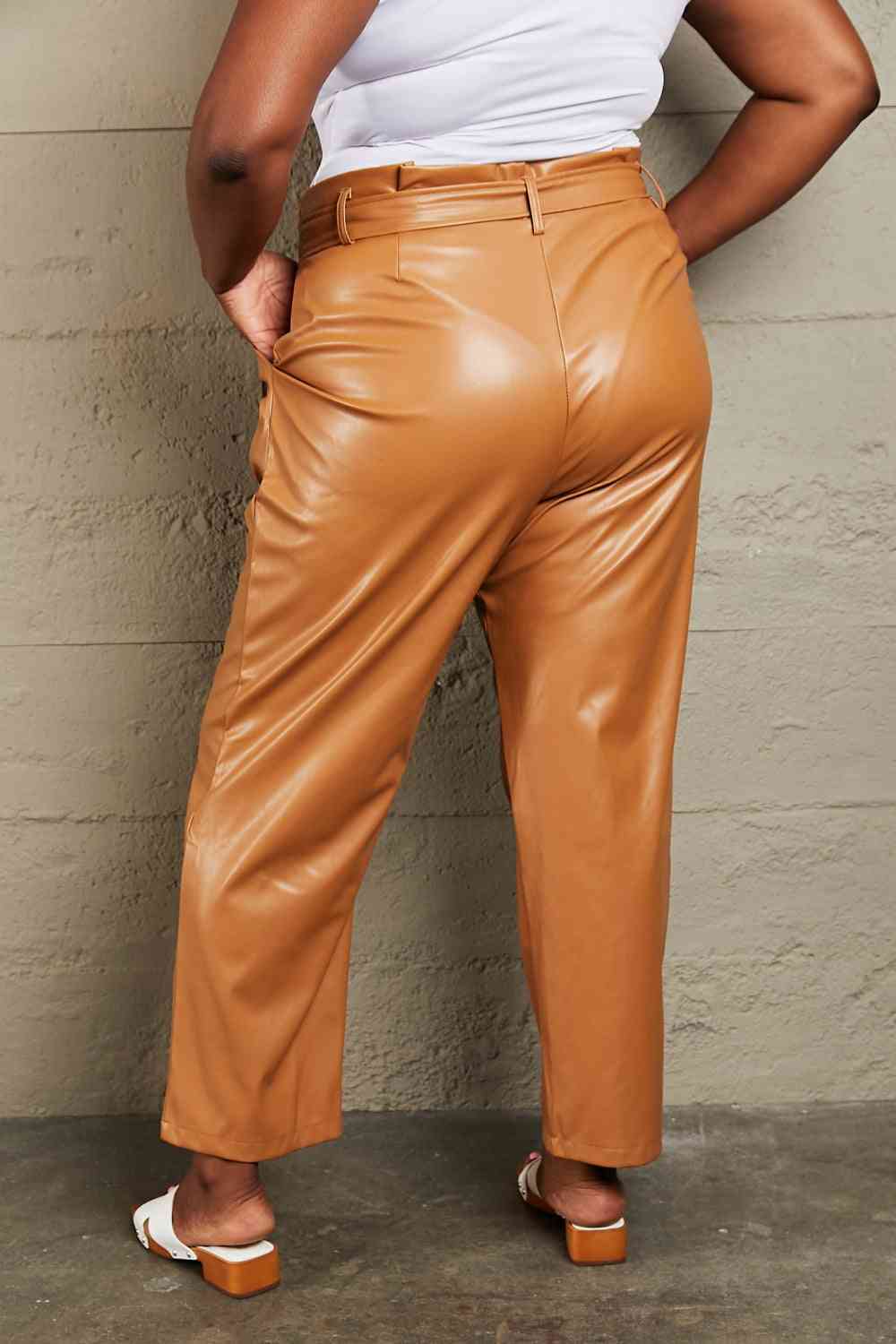 Indulge in opulence and ease with these 3 XL Full Size Faux Leather Pants. These stretchy, multi-purpose pants showcase a sophisticated waist belt and an alluring paper bag waist design. Whether for a glamorous evening out or a casual and fashionable look, elevate your wardrobe with this essential item