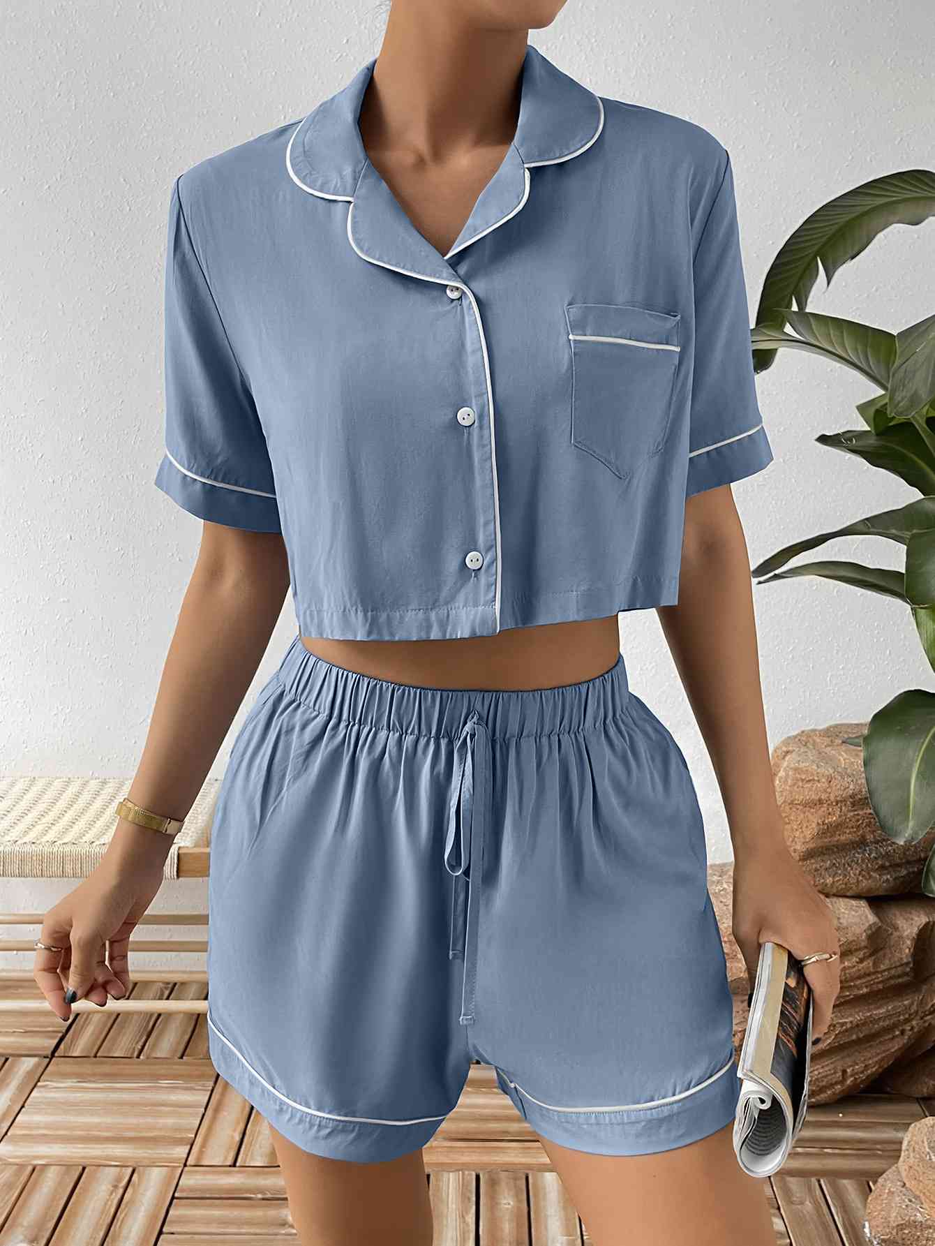 Discover the versatile Contrast Lapel Collar Cropped Shirt and Shorts Lounge Set, designed by Trendsi Trends for women, children, and young adults. Whether relaxing at home or a friend's residence, this two-piece pj set offers ultimate comfort and style.