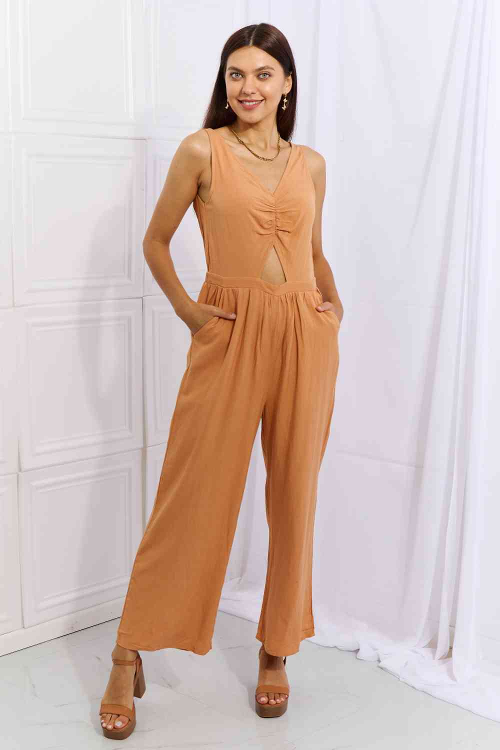 Trendsi Trends jumpsuit with mid cutout and pockets. Wide leg, V-neck is sleeveless for comfort and slender look.