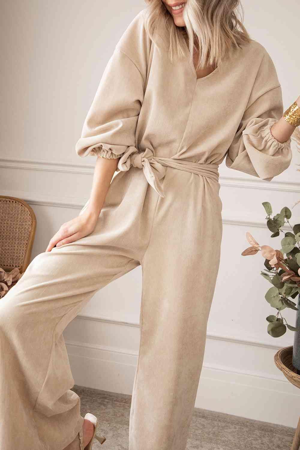Trendsi Trends Tie Waist Jumpsuit V-Neck Wide Leg. The Trendsi Trends Tie Waist Jumpsuit boasts a flattering V-neckline and wide-leg design, creating a stylish and comfortable outfit option. Its waist tie detail adds an extra touch of fashion-forward sophistication.